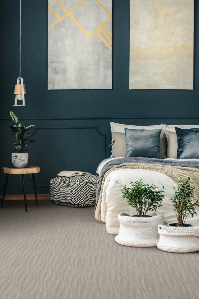 gray textured carpet in modern bedroom with blue accent wall and artwork